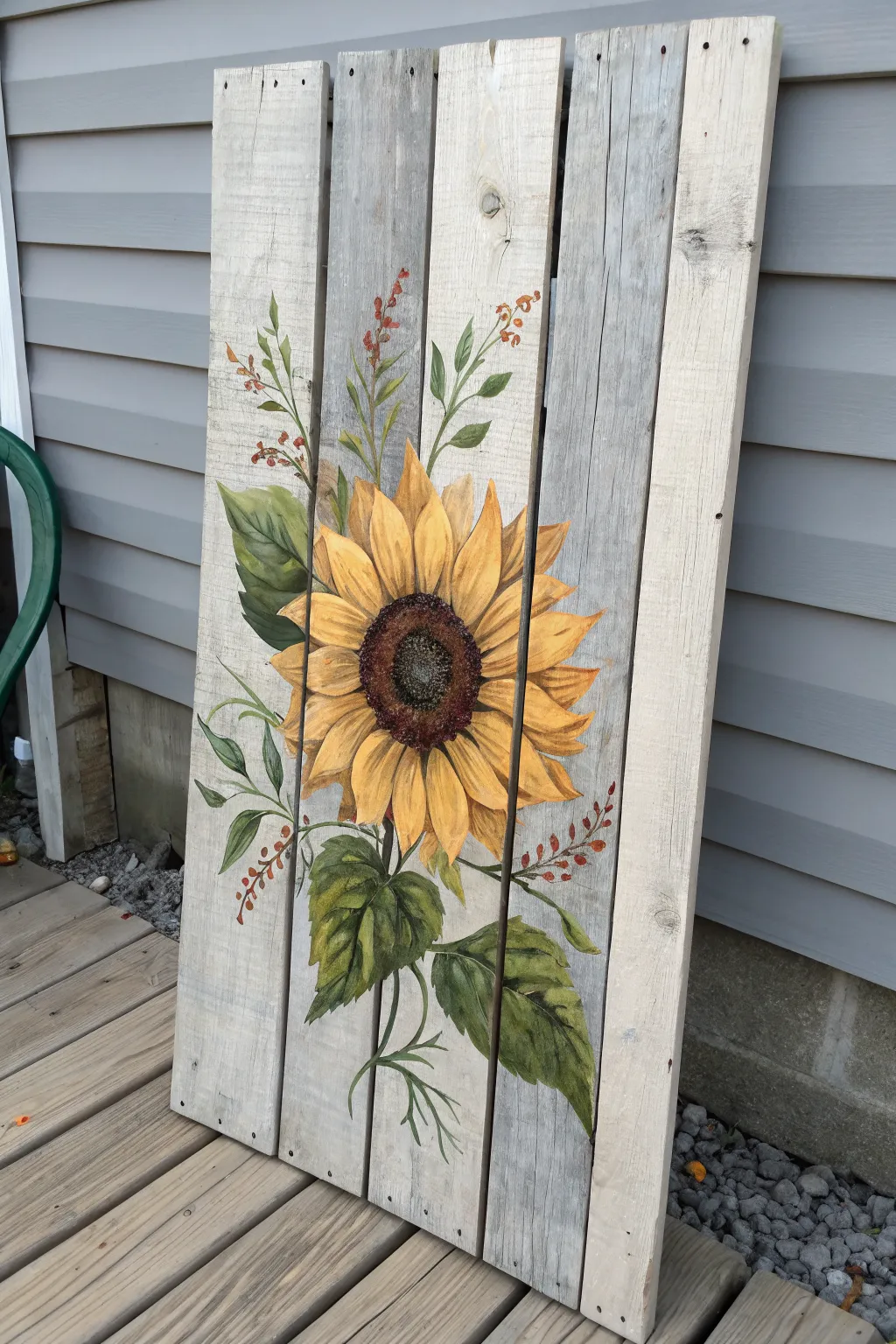 Cozy fall pallet art: bold sunflower corner and winding vines on weathered wood.