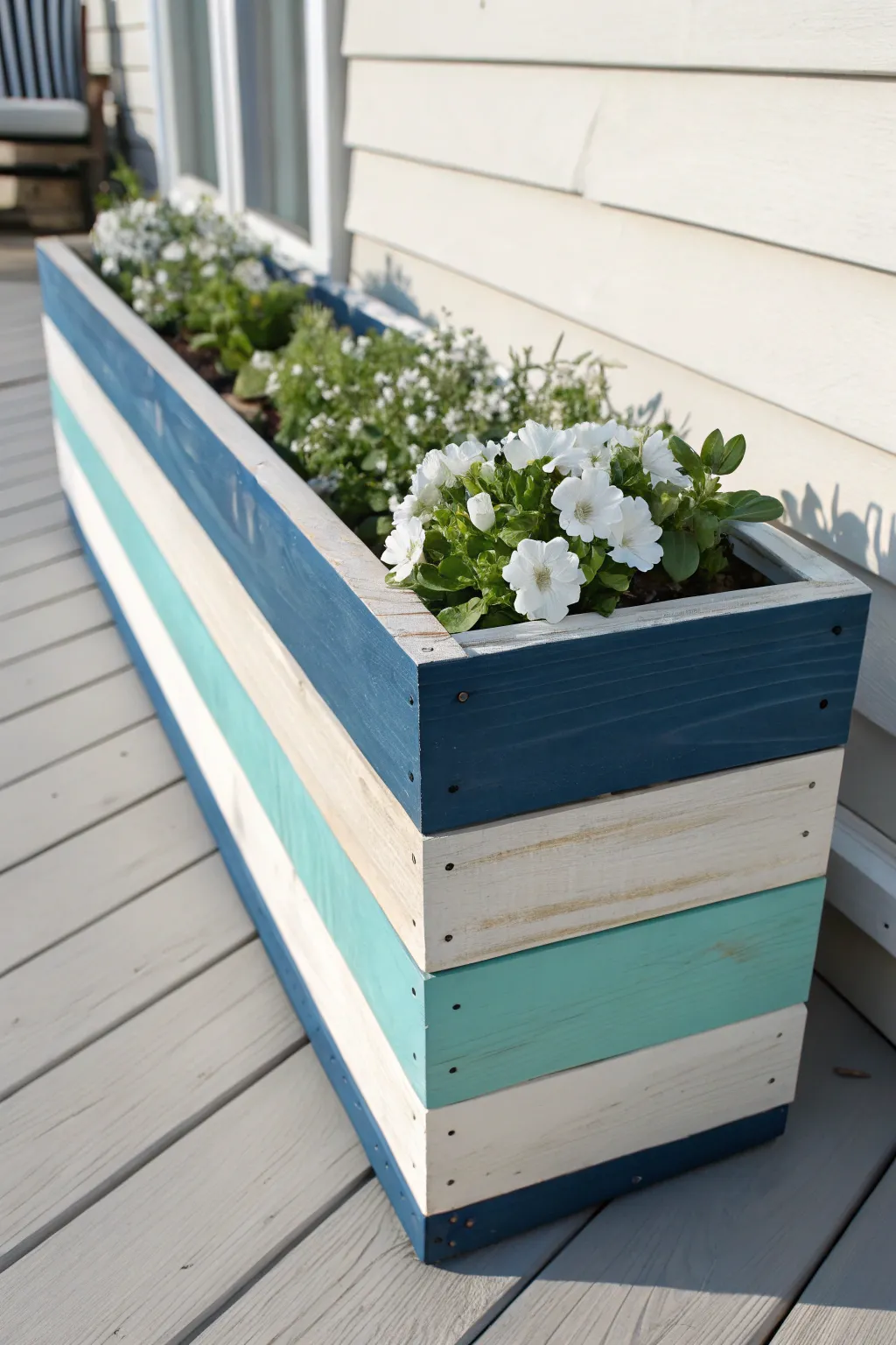 Striped coastal blues on a DIY flower box, styled with white blooms and silvery foliage