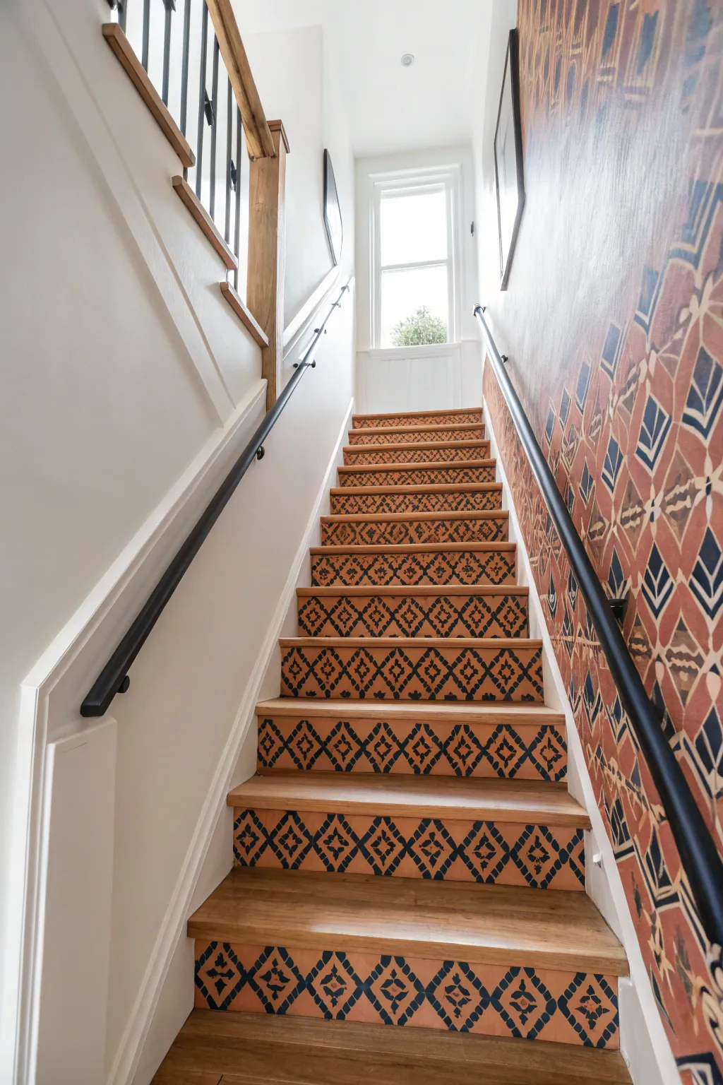 Let patterned wallpaper climb the stairs, balanced by calm walls for a bold yet airy moment.