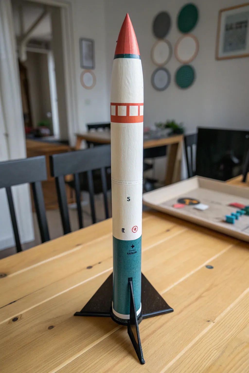 Minimalist model rocket with bold wide bands and clean stencil shapes for modern paint inspo.