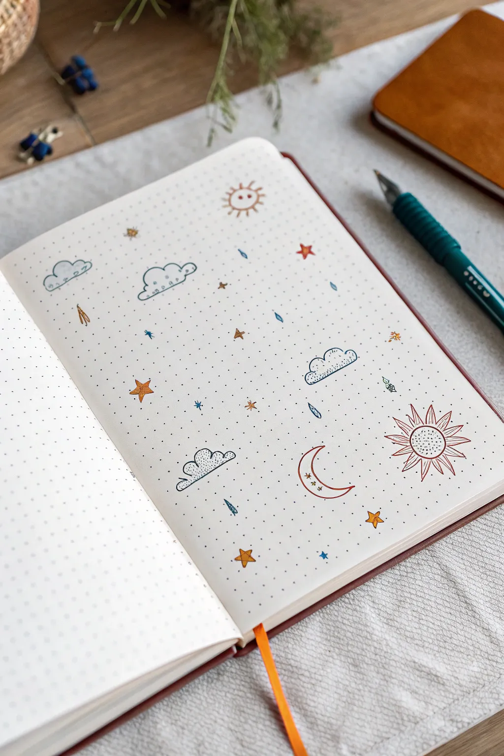 Minimal weather mini doodles on a dot grid notebook page, bold boho colors and calm scandi style