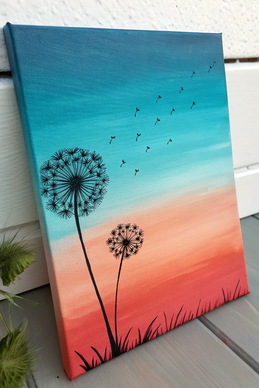Dandelion wish silhouette over a bold ombre sky, clean minimalist canvas painting idea
