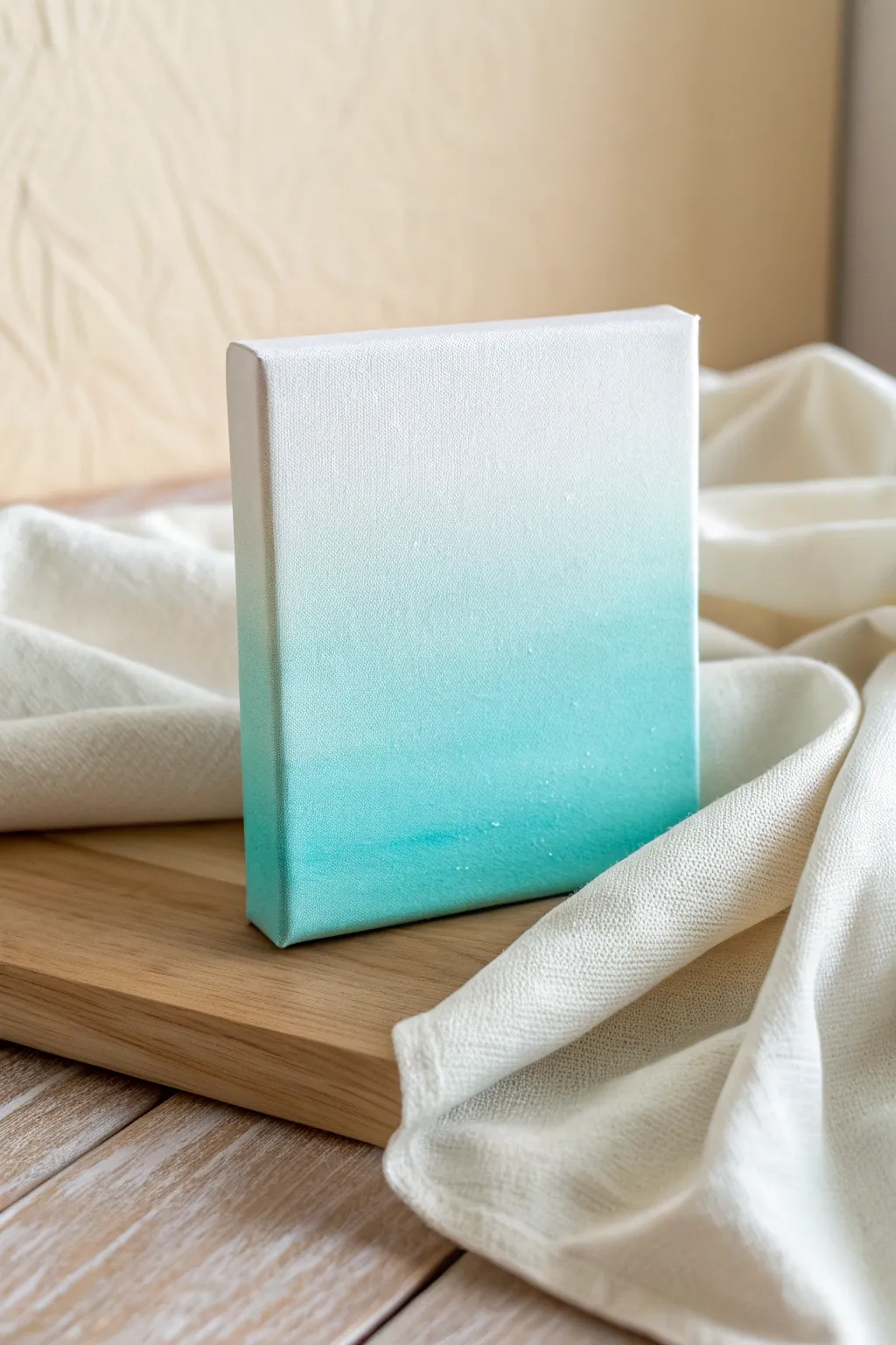 Calm pastel ombre canvas in mint to sky blue, styled with linen and sketch paper.