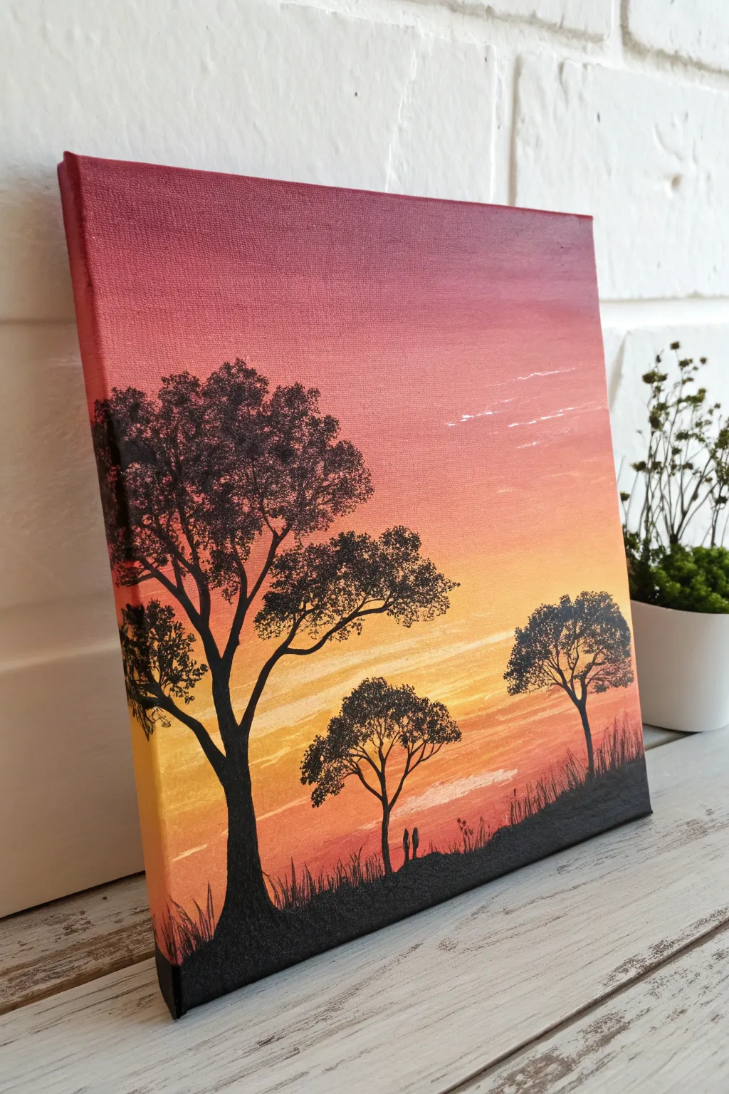 Bold sunset gradient with crisp black tree silhouettes, an easy canvas idea with striking contrast.