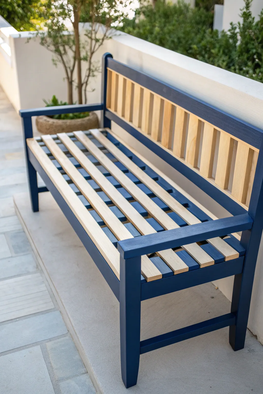 Bold striped paint transforms a simple patio bench into a modern Scandinavian-boho focal point.