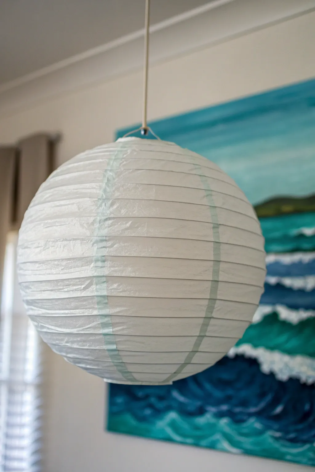 Breezy ocean-wave paper lantern with seafoam highlights, a calm Scandinavian-boho statement piece