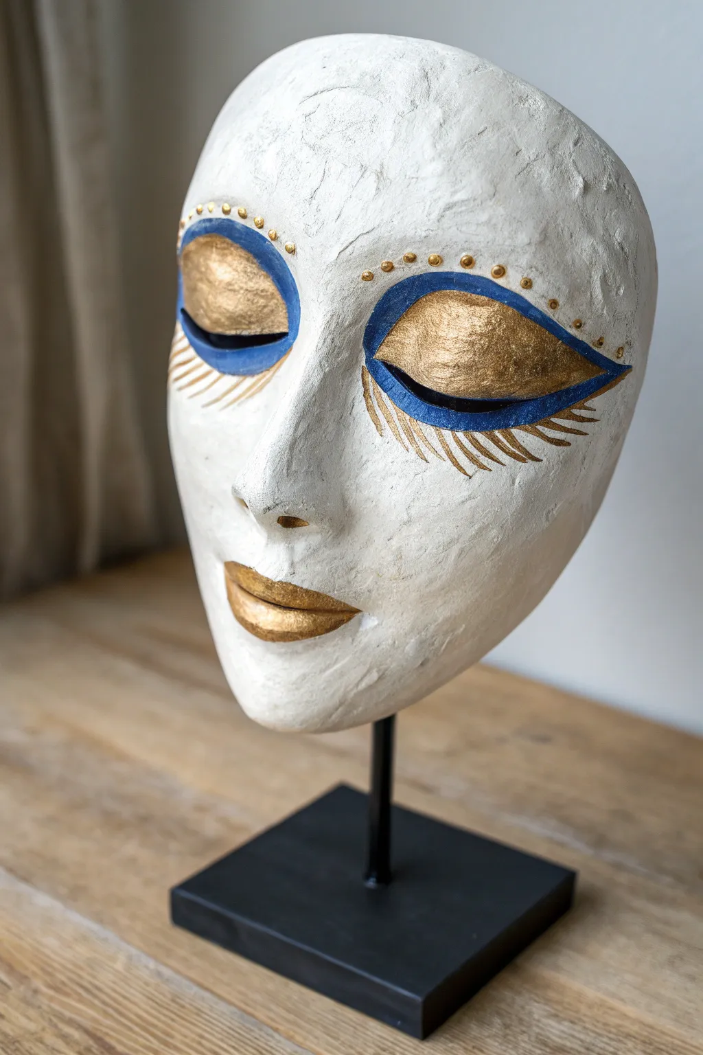 Closed-eye plaster mask with painted lids, minimalist Scandinavian styling with a bold boho pop.