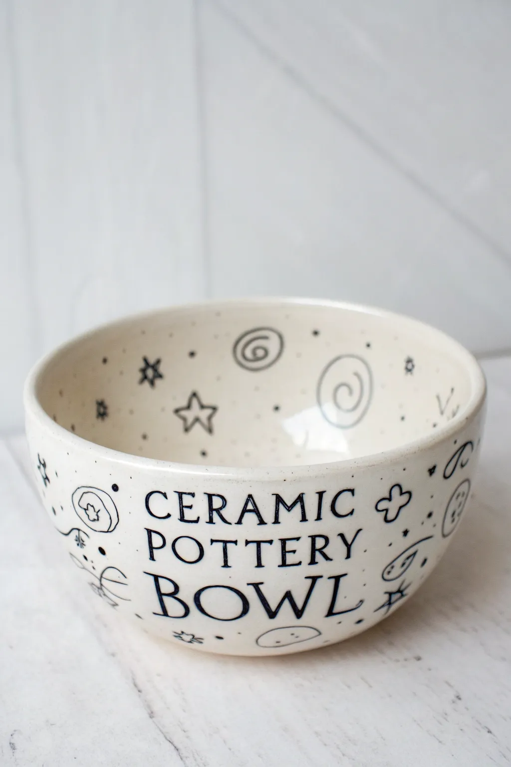 Minimal doodle bowl with airy line art and negative space, a sketchbook look in clay