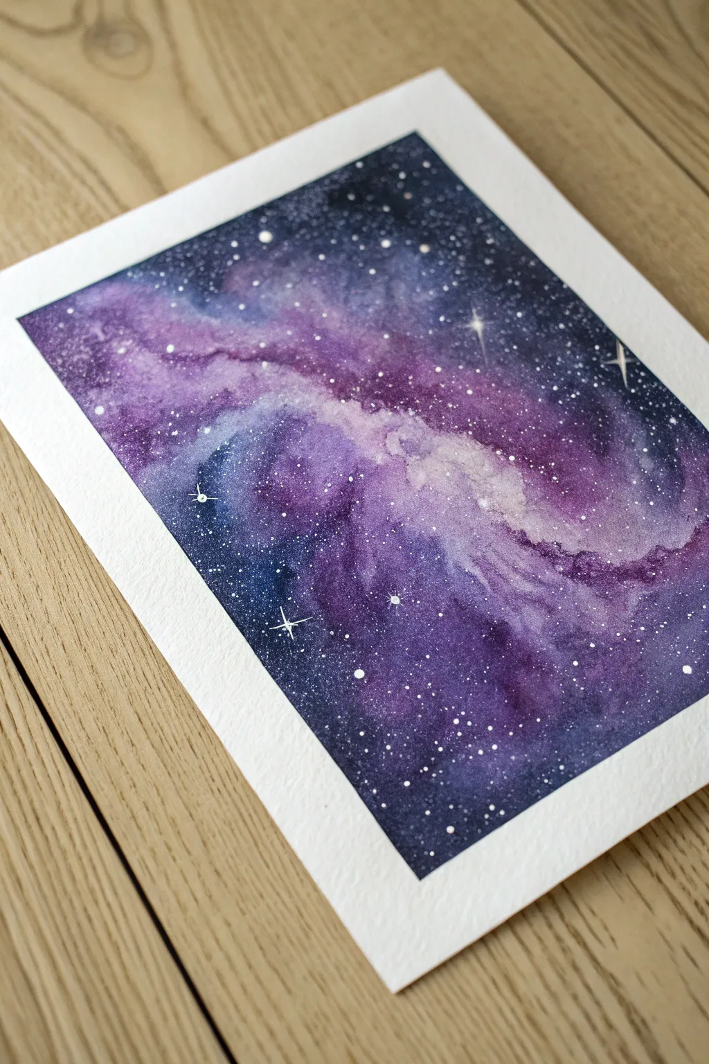Easy purple galaxy painting idea with simple splatter stars and one bright focal cluster.
