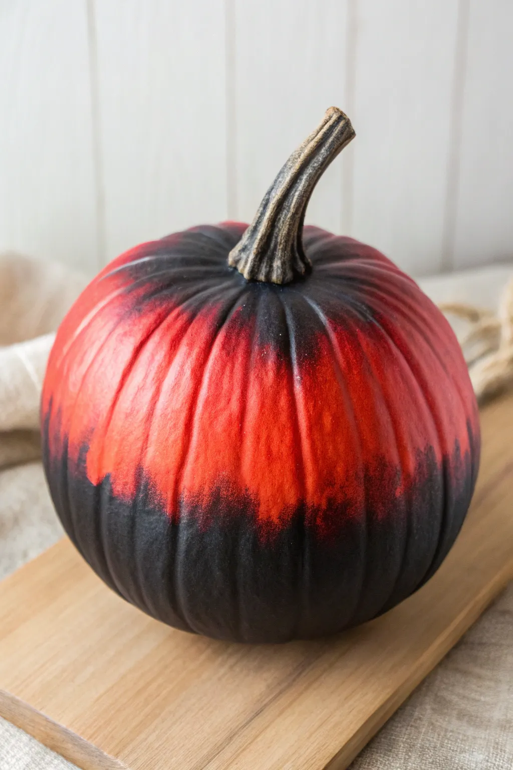 Try a bold red-to-black ombre pumpkin for a modern Scandinavian autumn centerpiece.
