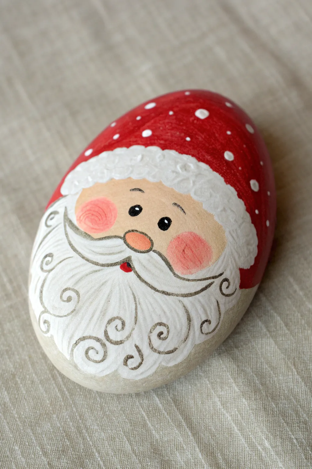 Curly beard swirl Santa rock idea in bold red and white, perfect for minimalist holiday crafts