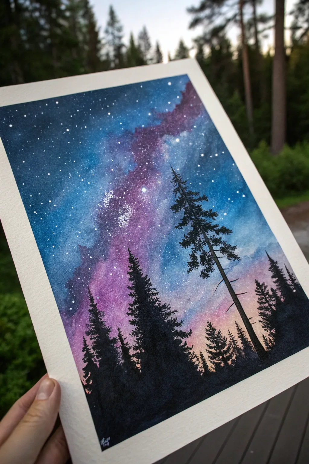 Bold cosmic gradients above crisp pine silhouettes, a minimal boho nightscape to paint.