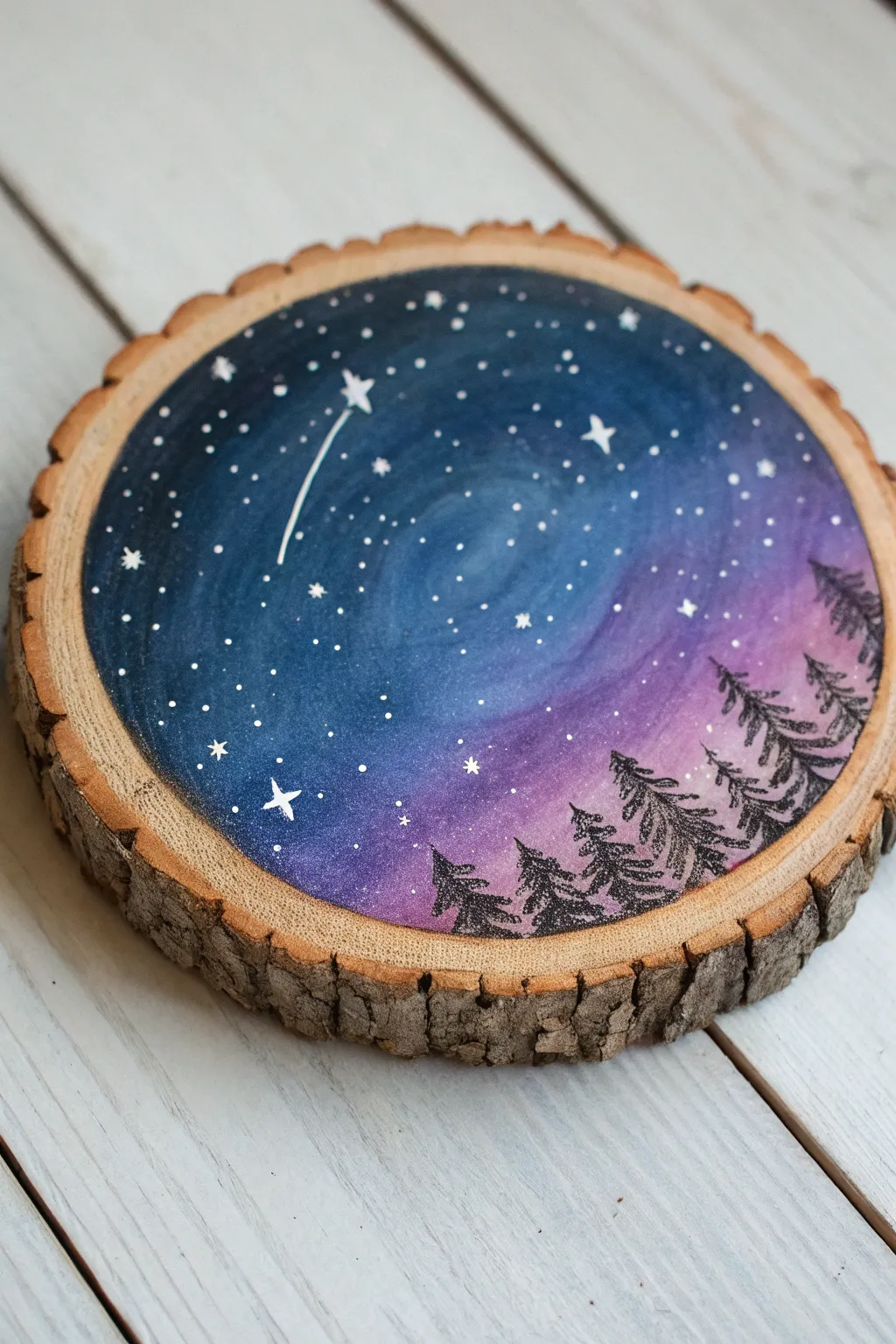 Starry galaxy on a wood round, bold indigo tones with a soft milky haze and raw wood edge.