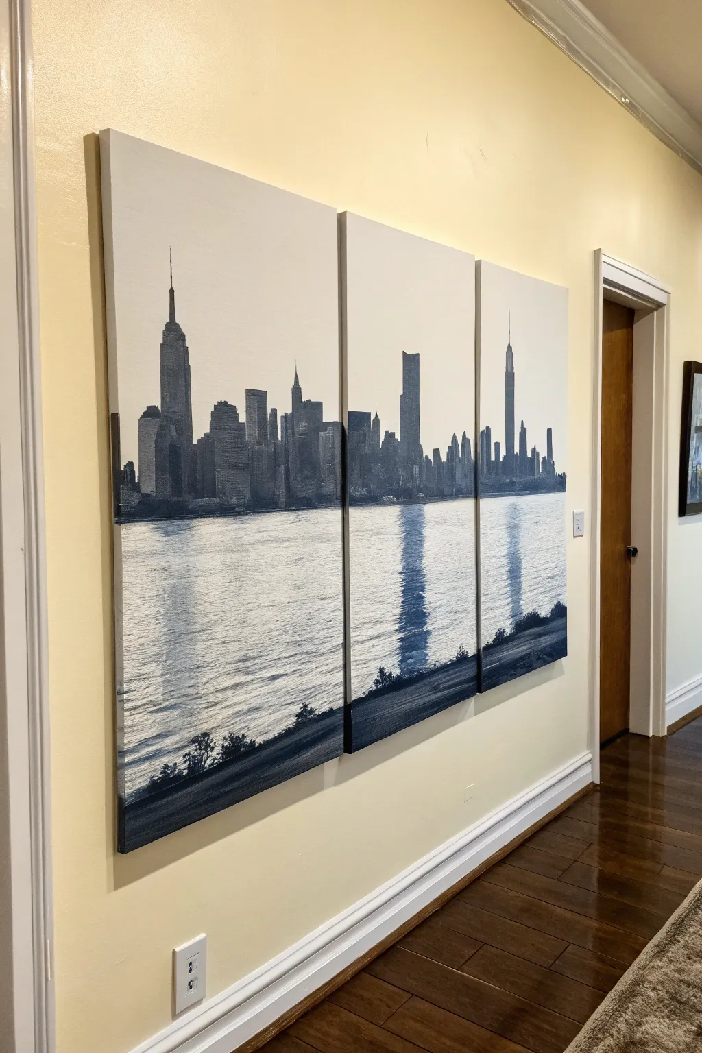Minimal triptych skyline: tallest towers centered, reflections flow across all three panels.