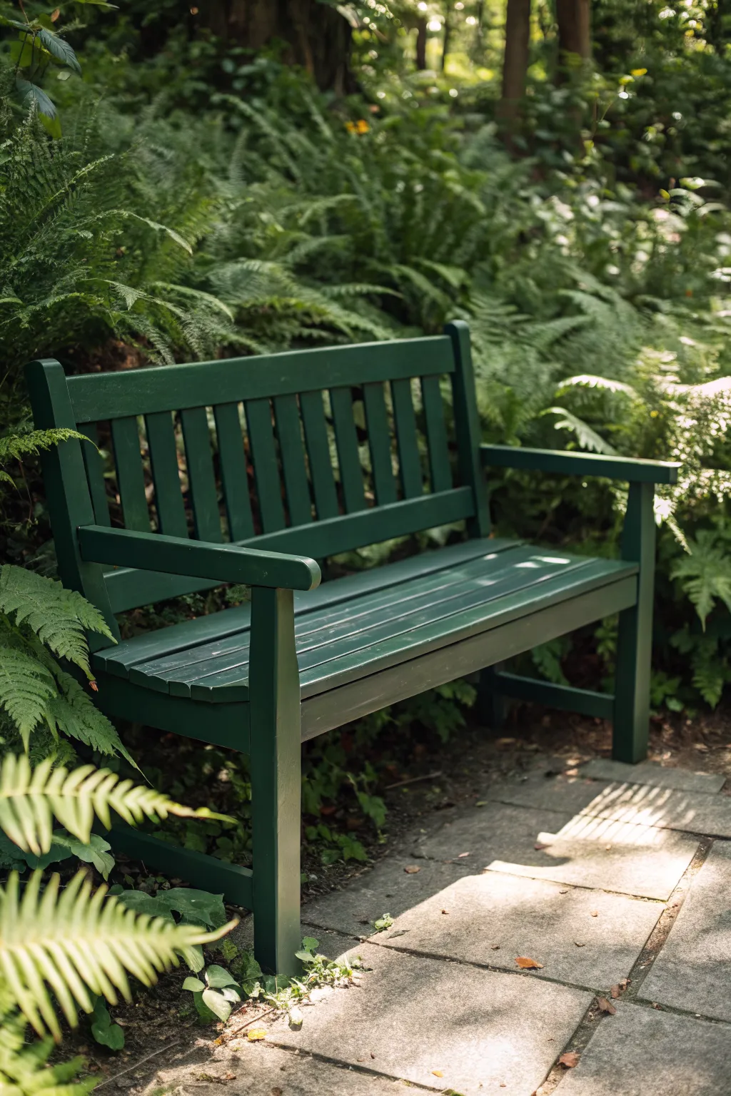 Deep forest green bench nestled in foliage, a quiet hideaway with soft dappled light.