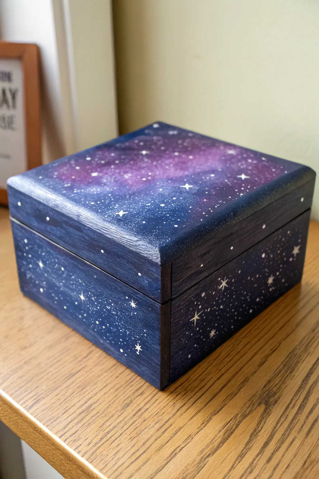 Sponge-painted galaxy box in deep blues and purples, minimal desk styling, crisp star splatter.