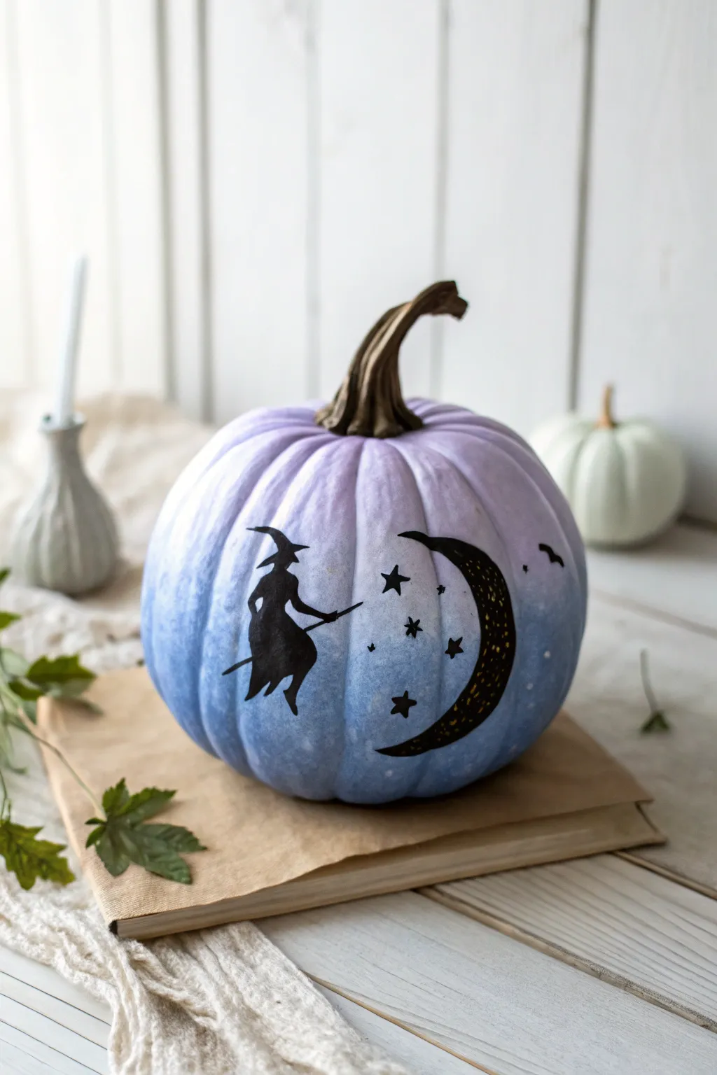 Twilight pumpkin with a flying witch silhouette, crescent moon and tiny stars for spooky charm