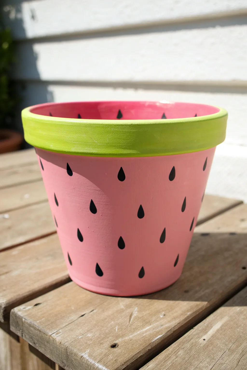 Bring fresh summer vibes to your home with this adorable DIY watermelon painted pot.