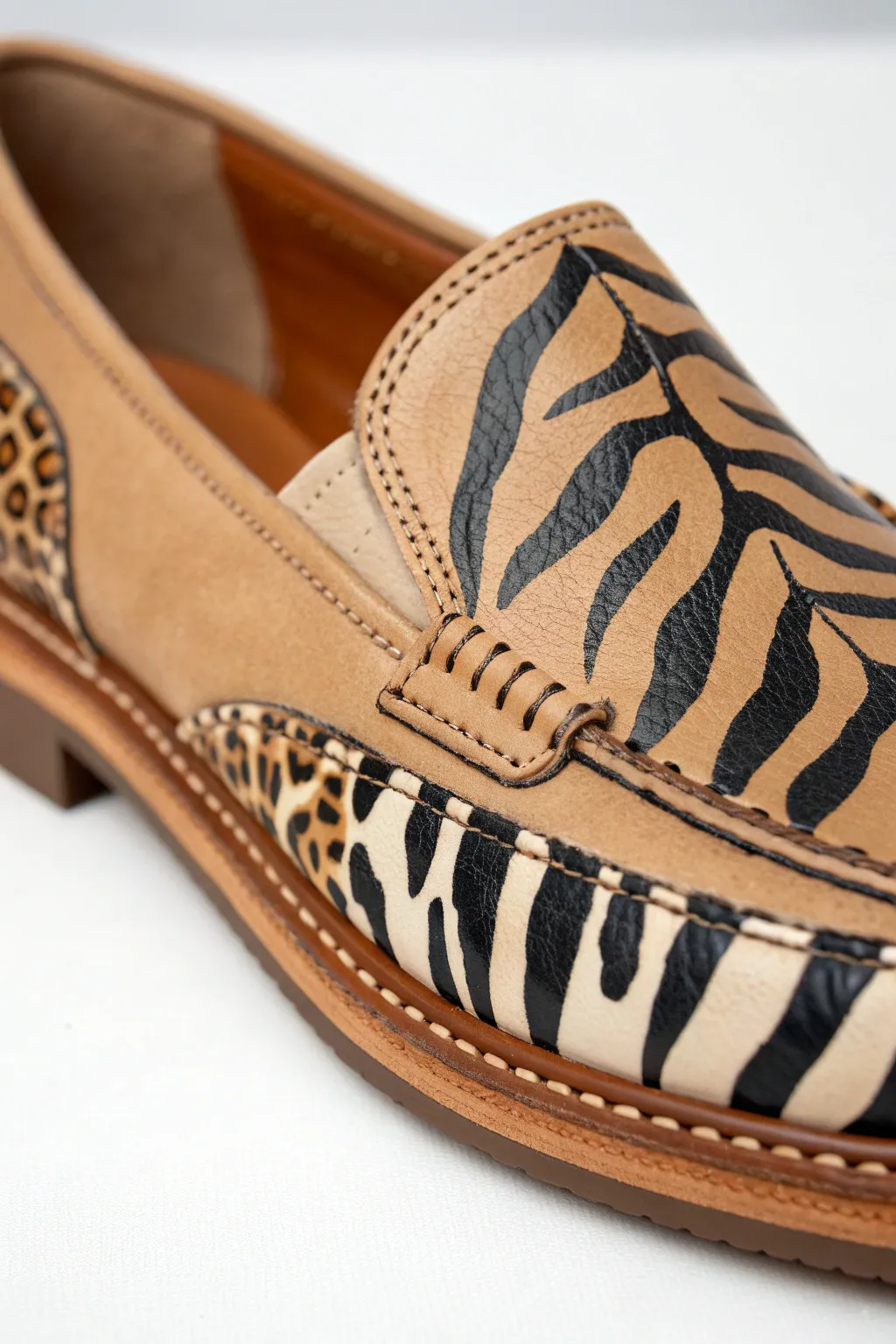 Animal print spots and stripes on a tan shoe side, crisp brushwork with clean minimalist contrast.