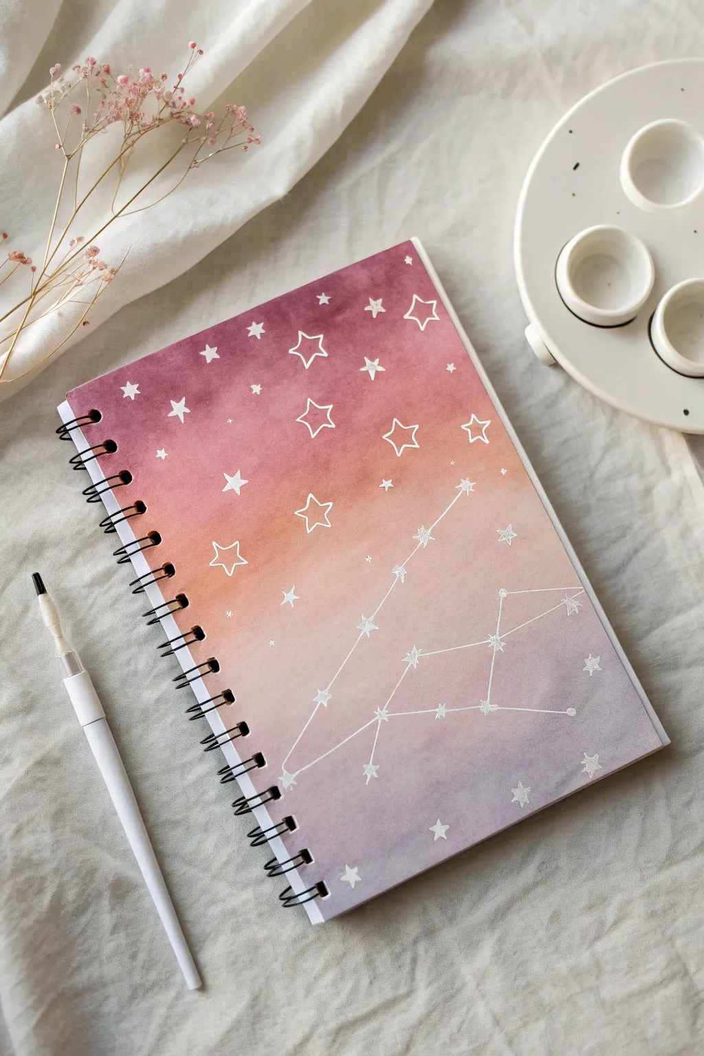Dreamy watercolor wash sketchbook cover with crisp white ink stars for soft, minimal charm