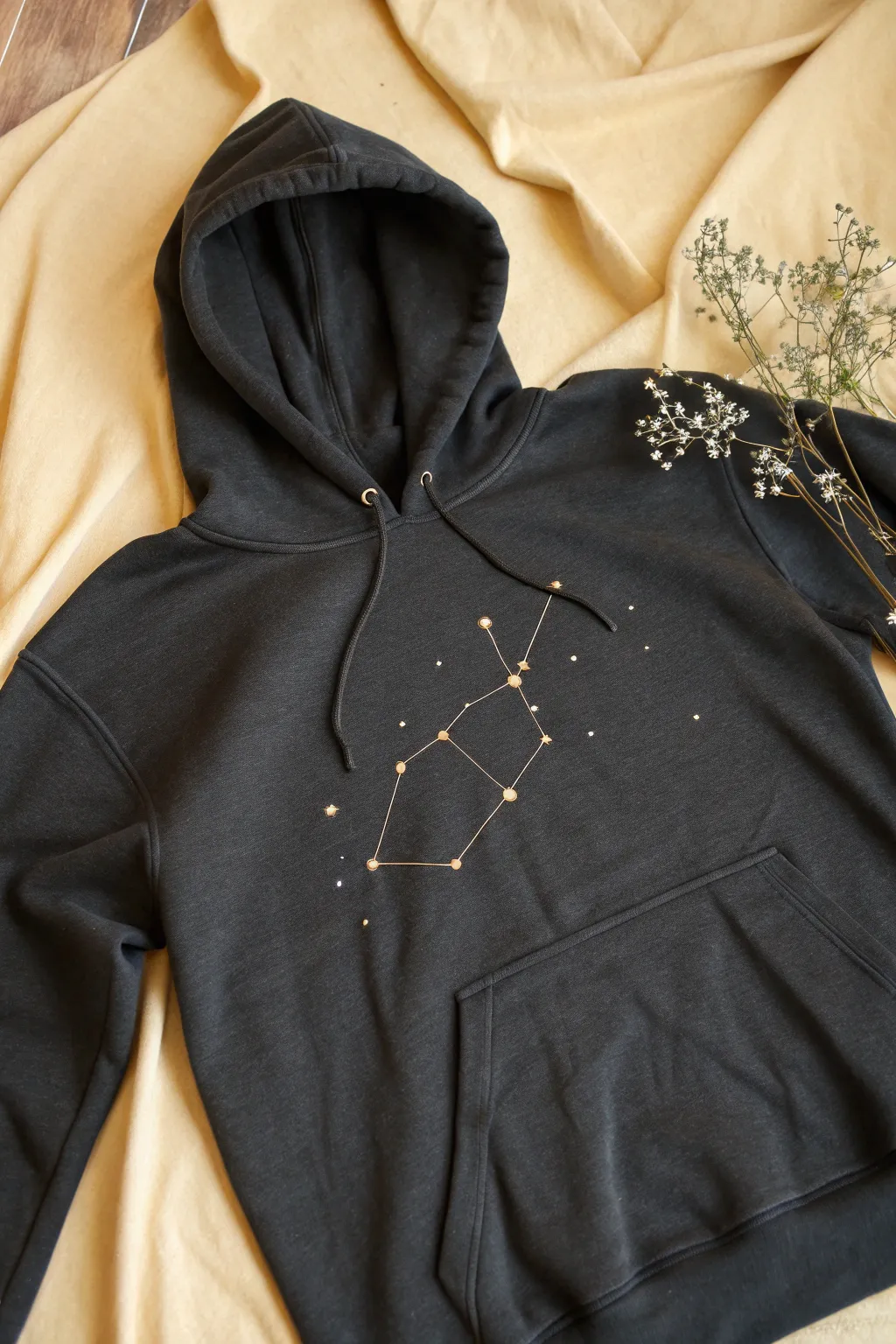 Starry 3D fabric paint constellations on a dark hoodie, with crisp raised dots and lines.