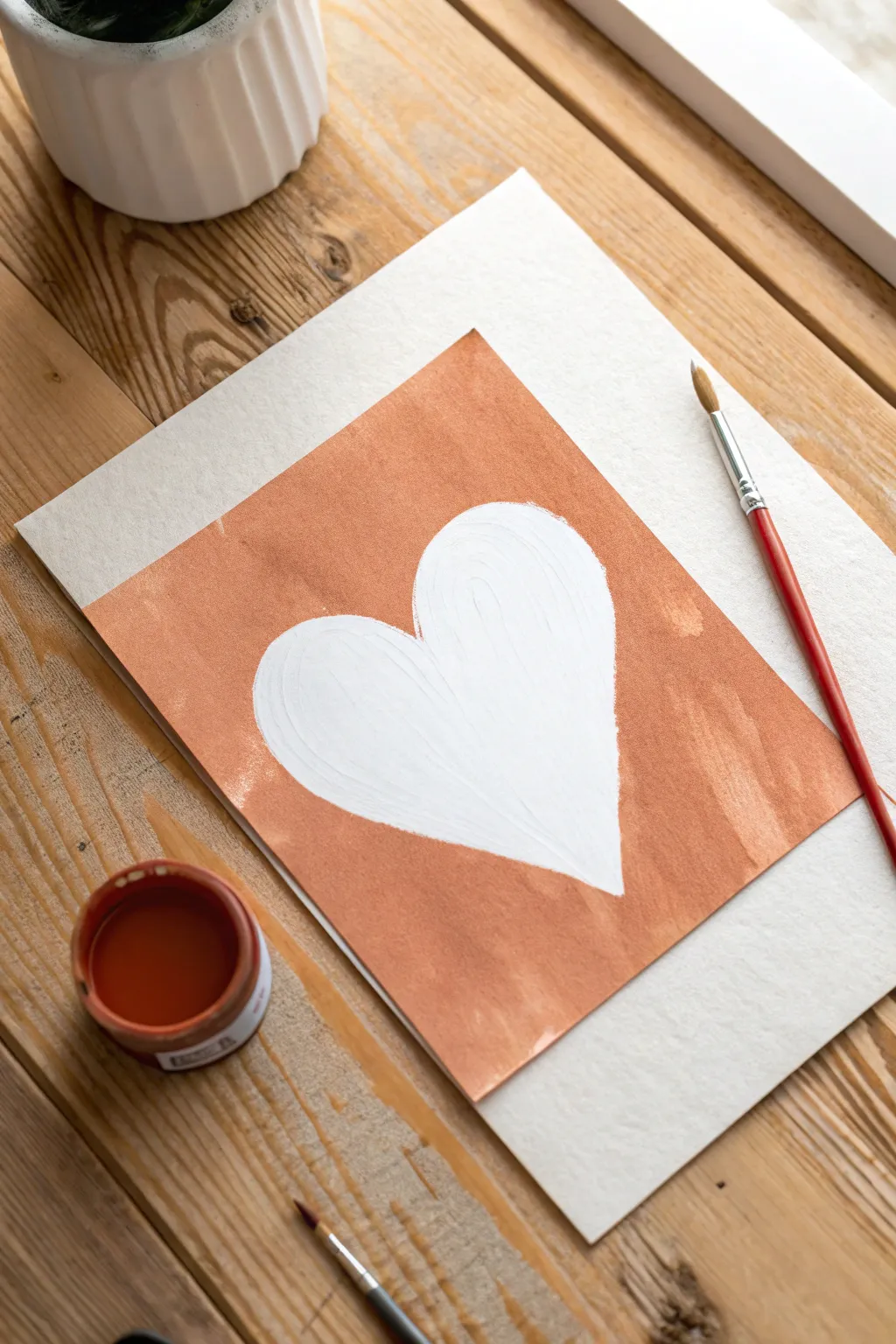 Crisp negative-space heart: keep it white and brush bold color around for striking contrast.