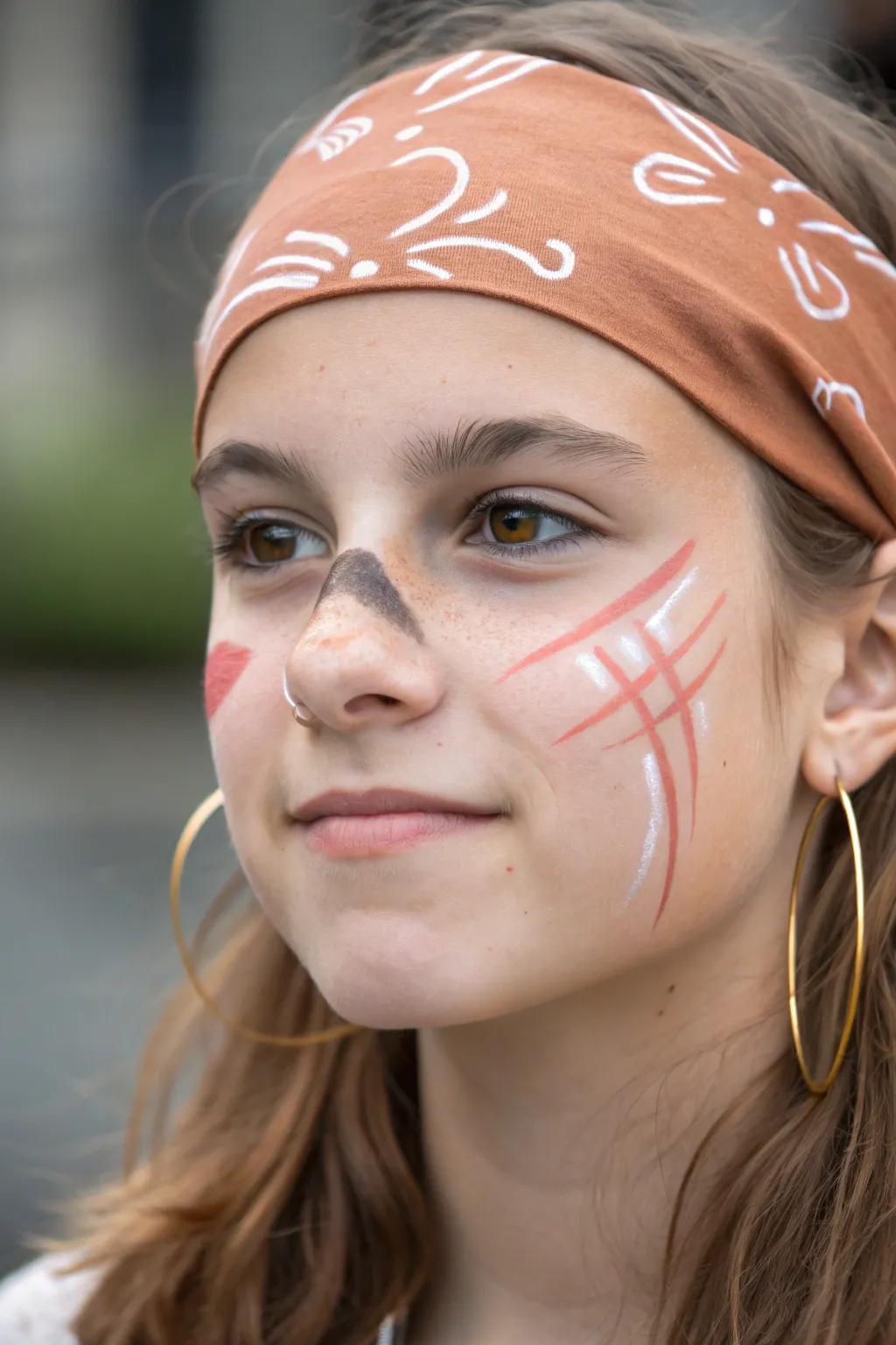 Minimal pirate face paint: painted bandana, cheek scar, and a tiny hoop earring illusion