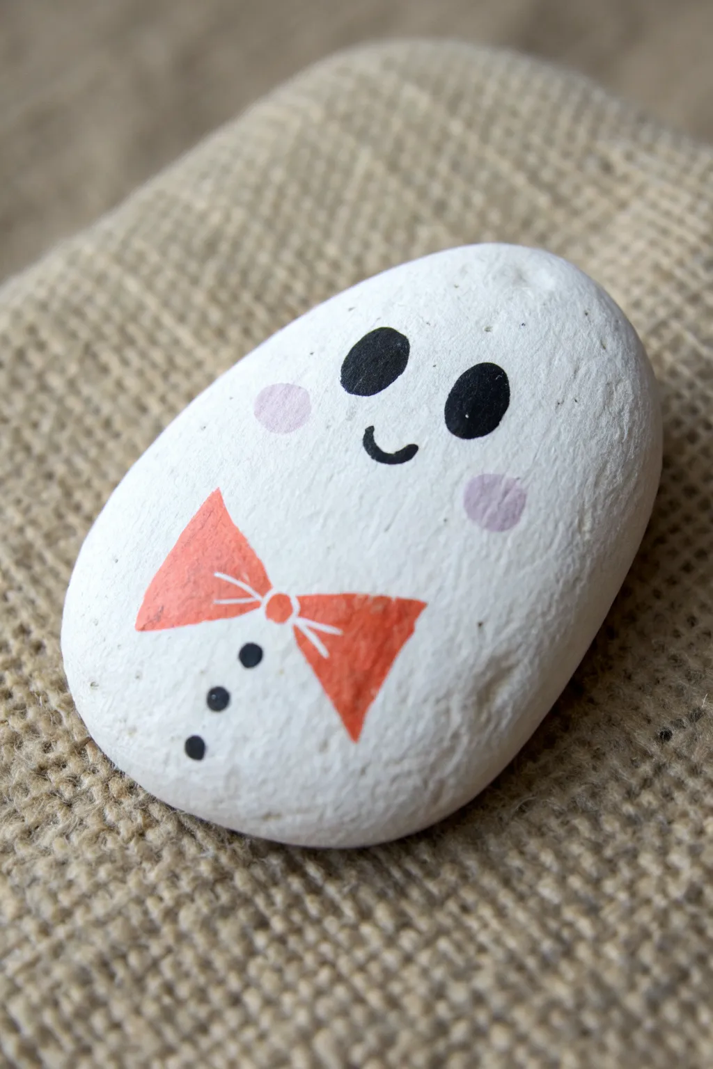 A sweet sheet-ghost rock with a bold bowtie accent, perfect for simple Halloween crafting.