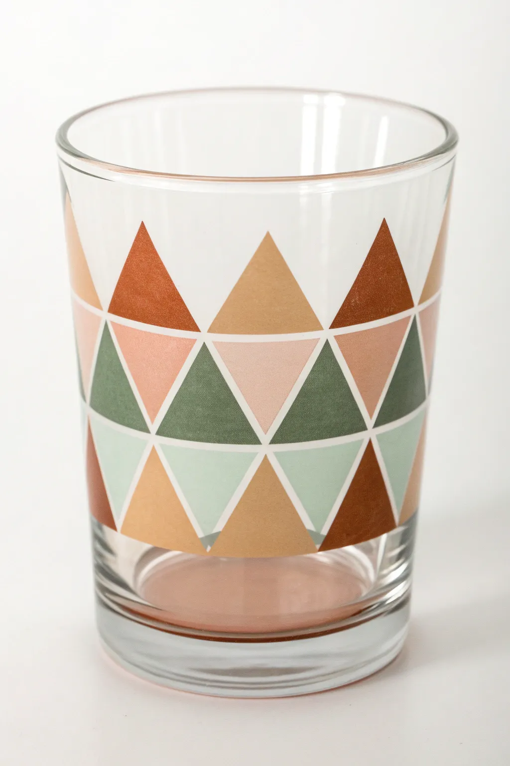 Crisp taped-style triangle color blocks on a clear glass tumbler, clean and modern boho
