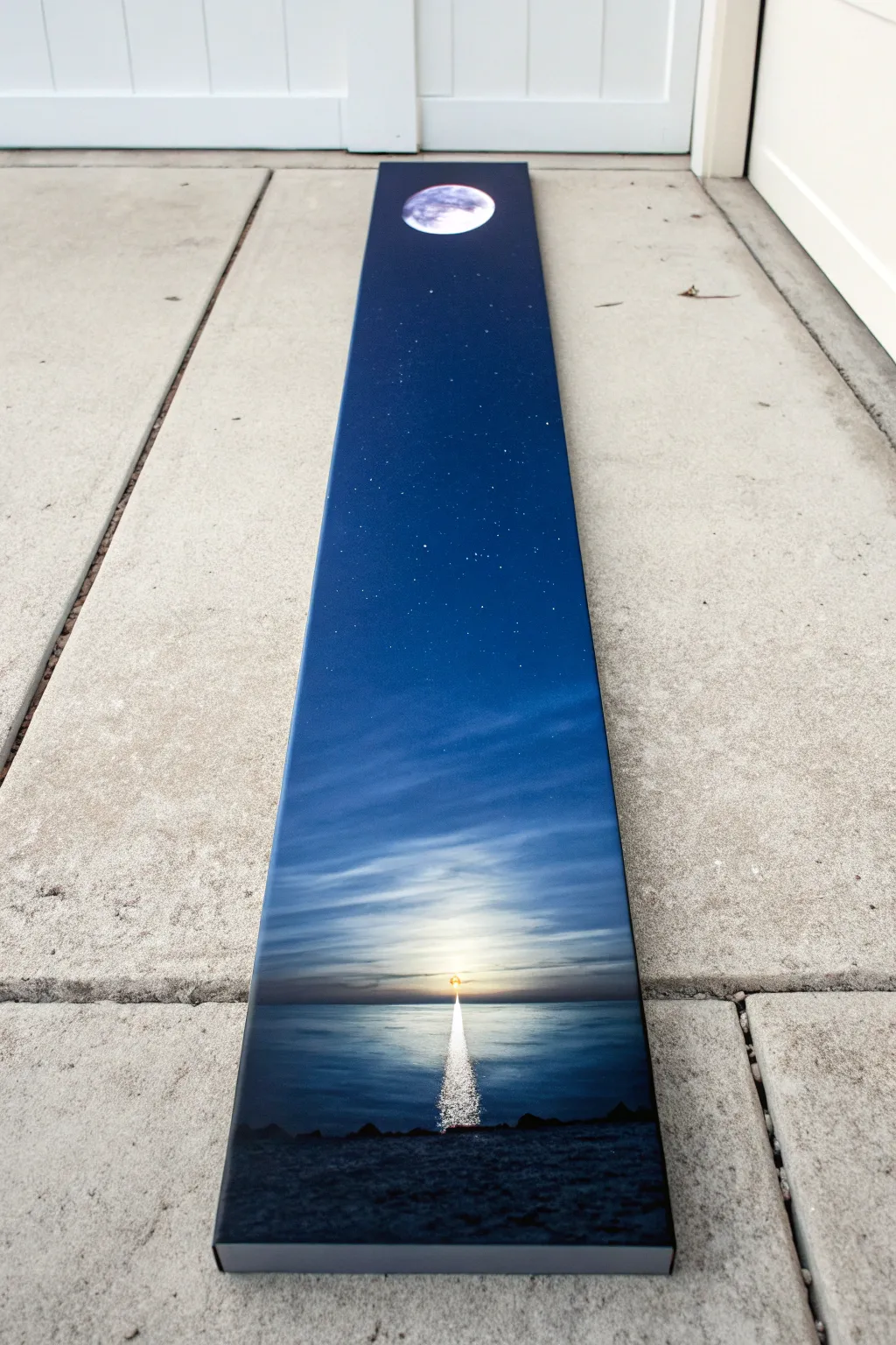 Vertical moonrise on a long canvas with deep indigo tones and a soft glowing light trail