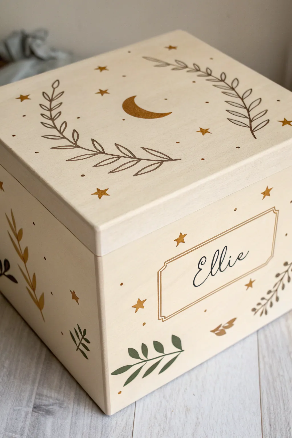 Baby milestone memory box in gentle neutrals with tiny hand-painted icons, simple and soothing