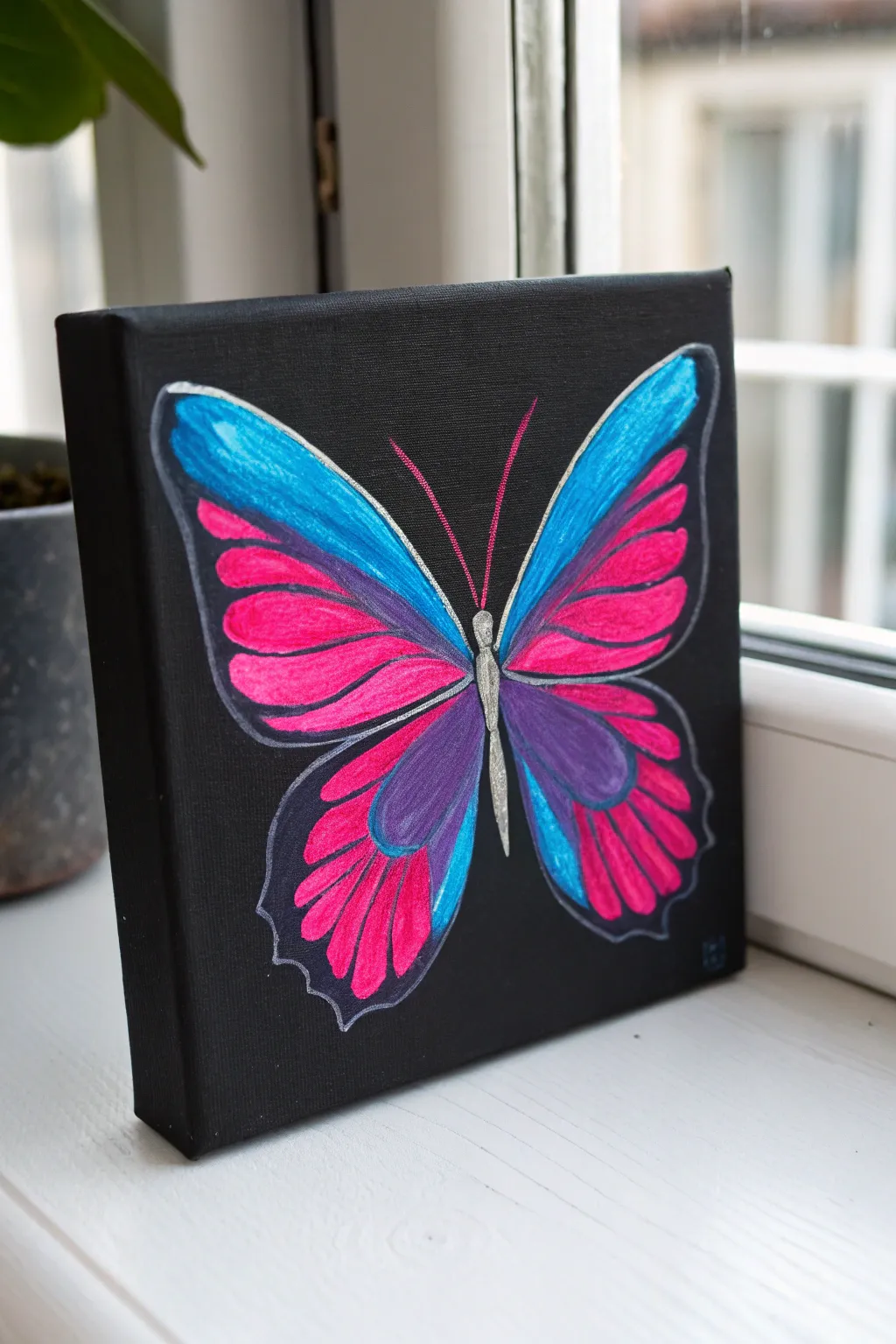 Bright neon-edged butterfly on a mini black canvas, simple, bold, and easy to recreate