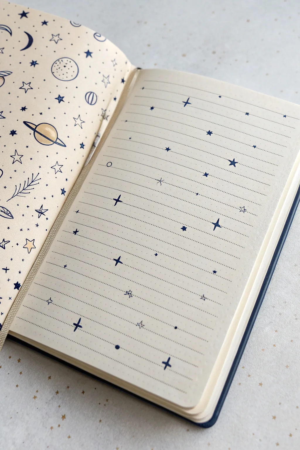 Dreamy space doodles scattered across an open notebook spread, stars and tiny ringed planets