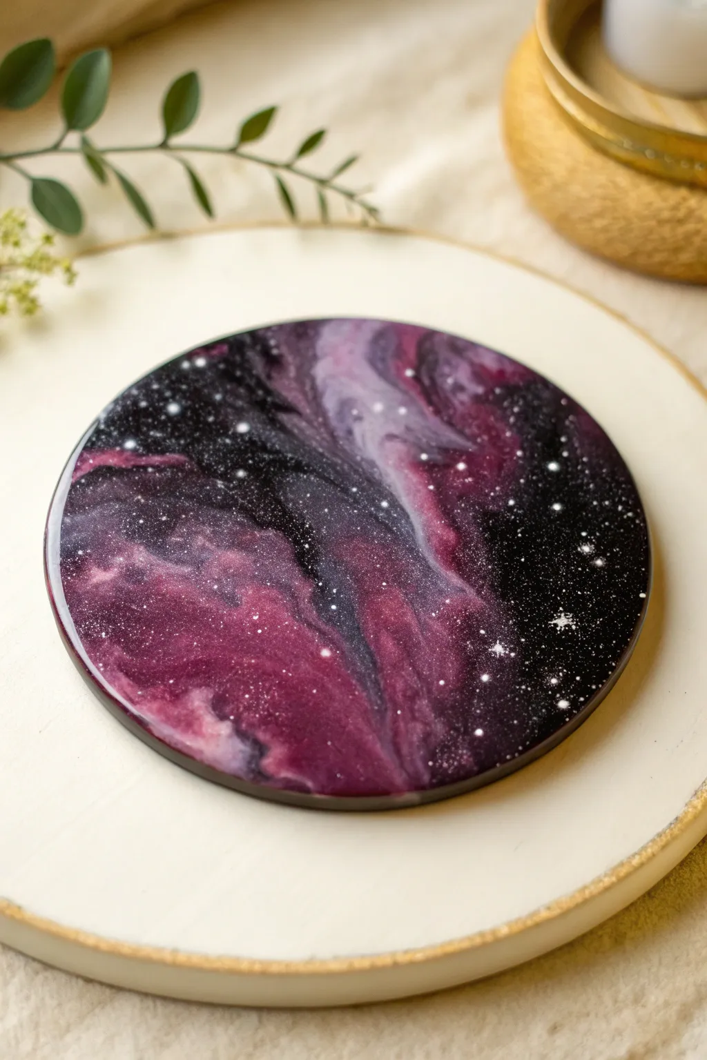 Galaxy-inspired resin round in inky black, purple, and magenta with starry white speckles