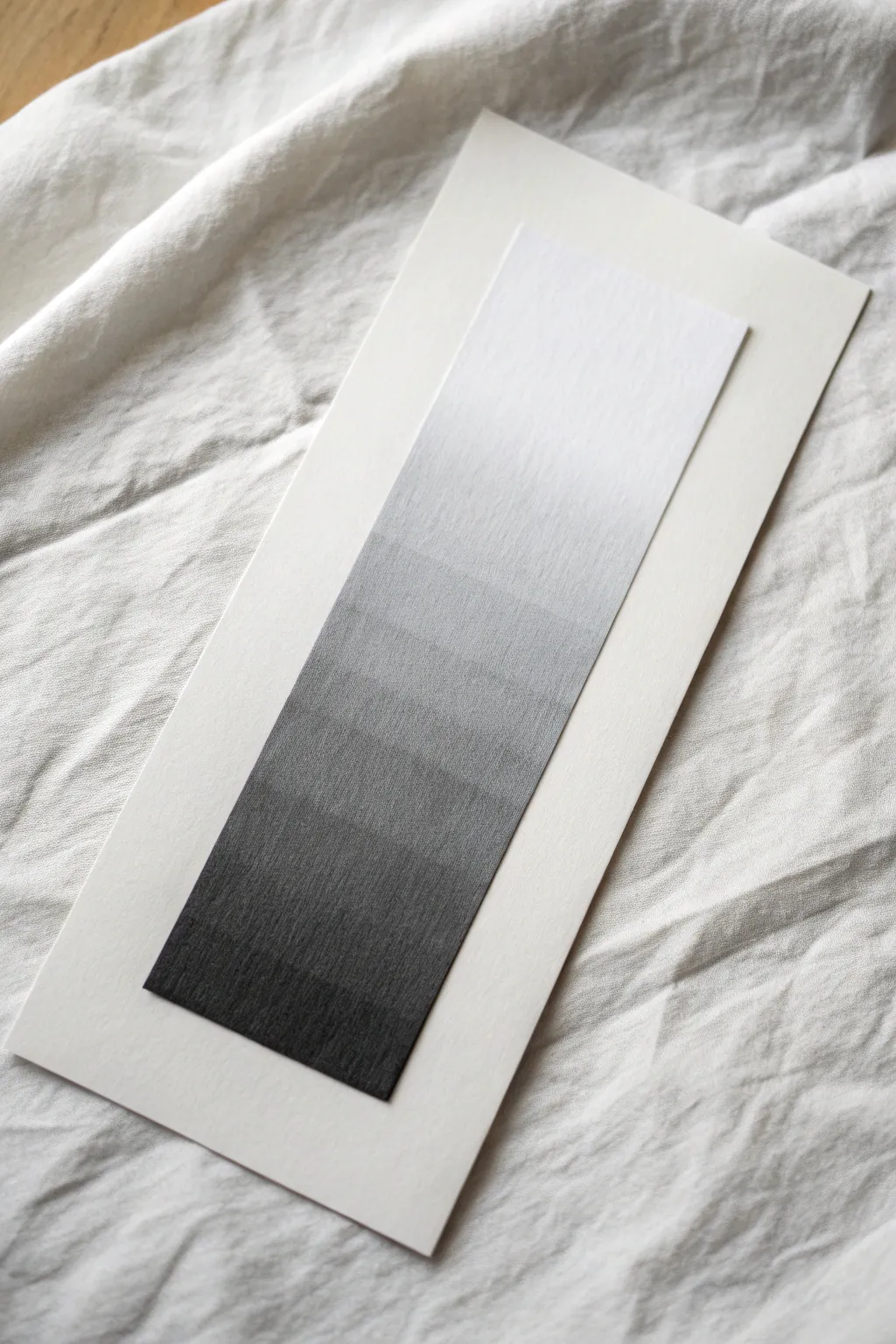 Super smooth graphite gradient blend from white to deep charcoal, close-up texture for shading practice.