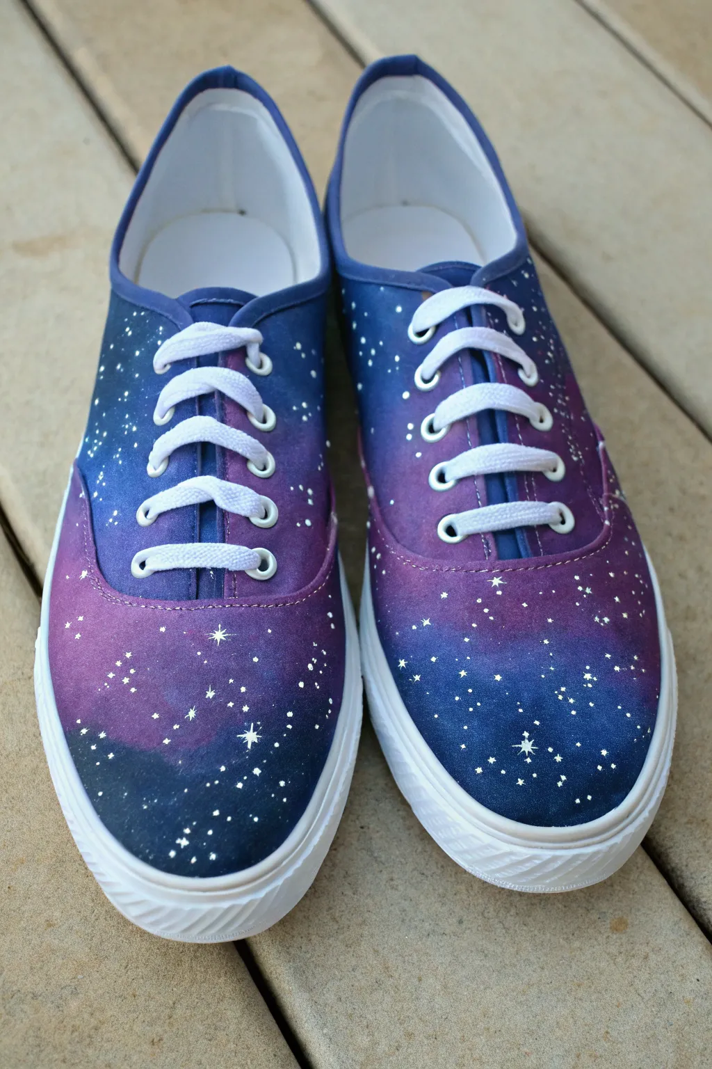 Galaxy-painted canvas sneakers with delicate star splatters and subtle constellations