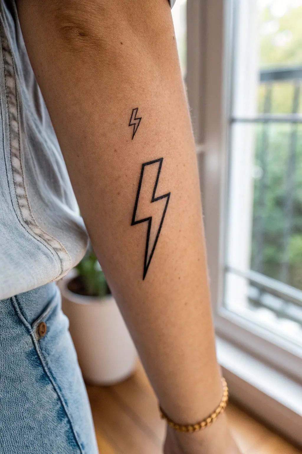 Crisp minimalist lightning bolt tattoo in bold blackwork, clean lines and high-contrast elegance.
