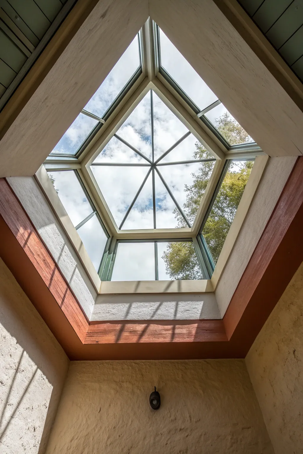 Geometric color panels inside a skylight well for a calm, modern ceiling statement