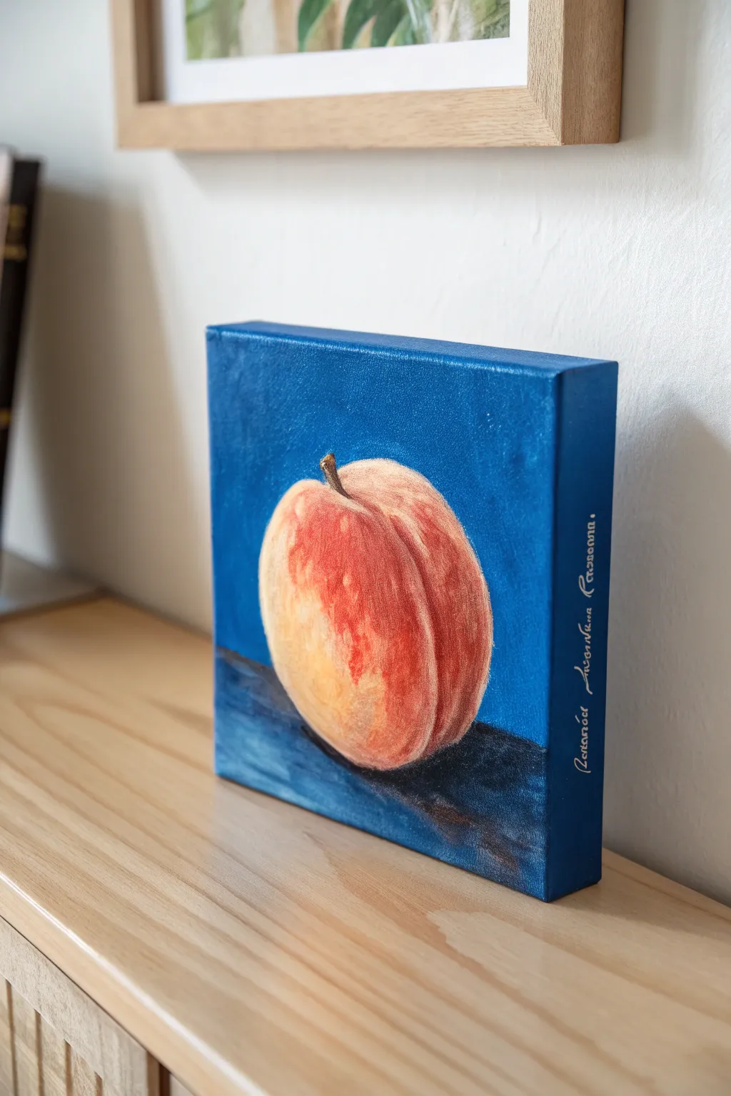 Single peach on a bold blue background, a simple small-canvas idea with modern contrast.