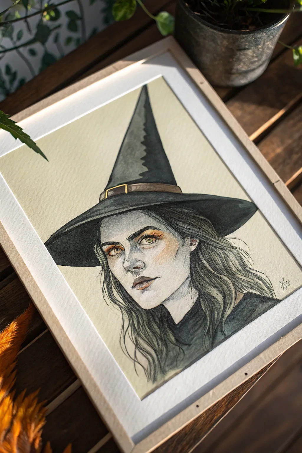Close-up witch portrait idea with a shadowed hat and softly glowing eyes, minimalist boho mood.