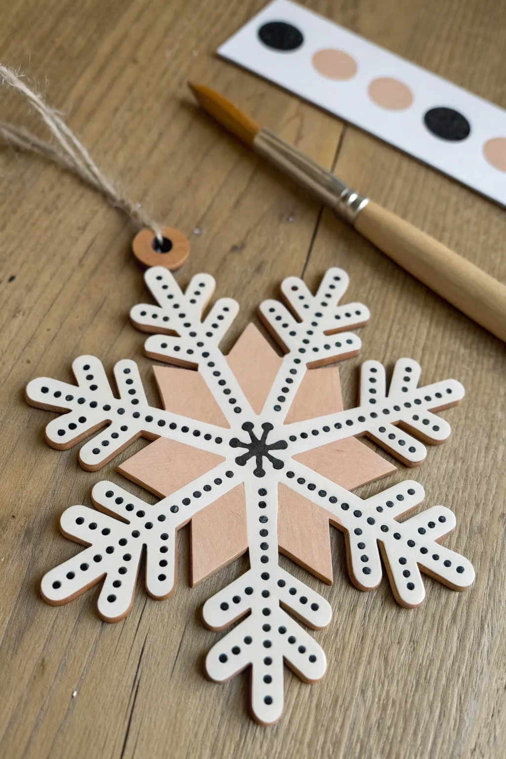 Polka dot wooden snowflake with dotting tool details in soft minimalist boho tones