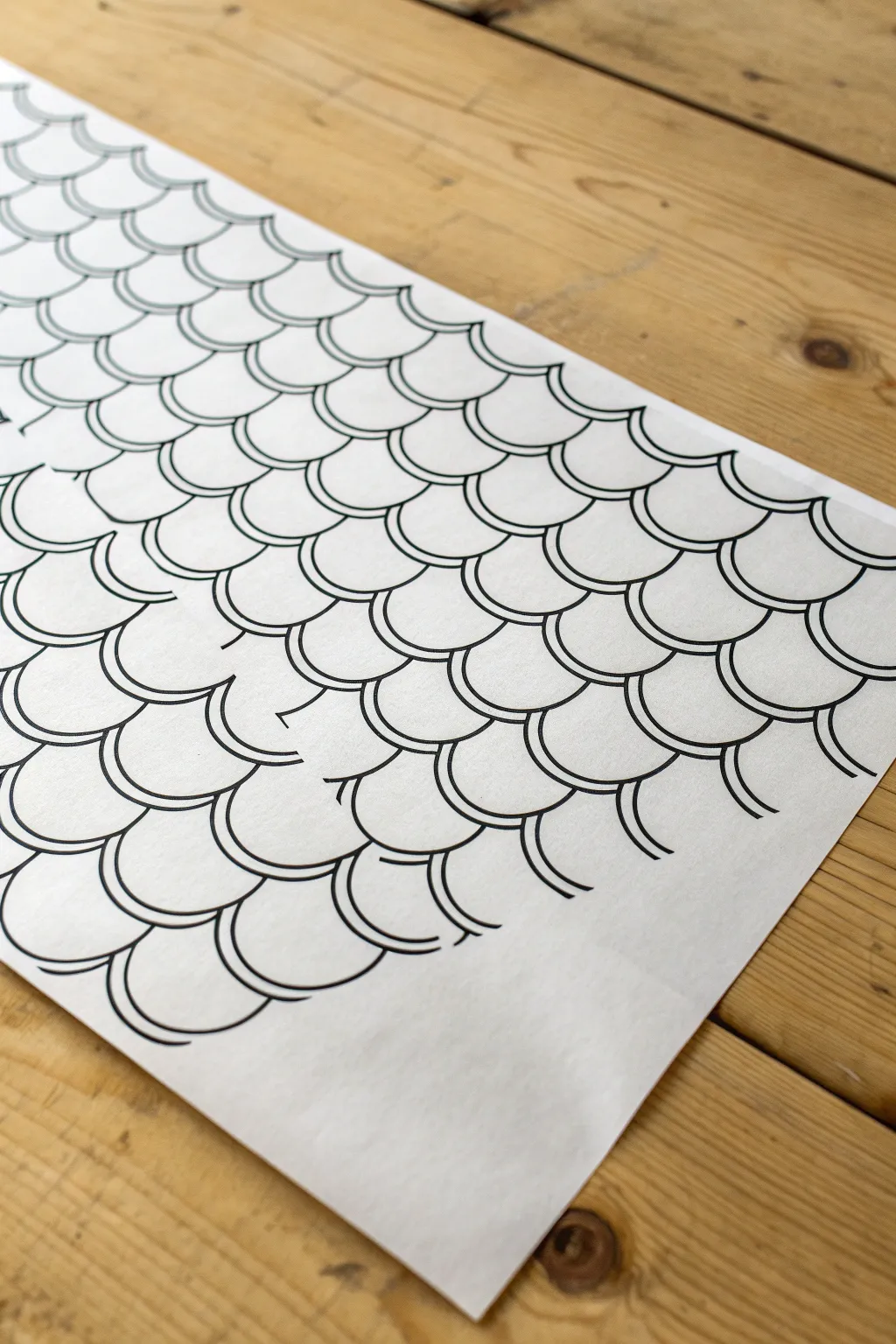 Fish-scale zentangle rows comparing tight and loose spacing in a clean minimalist pattern study.