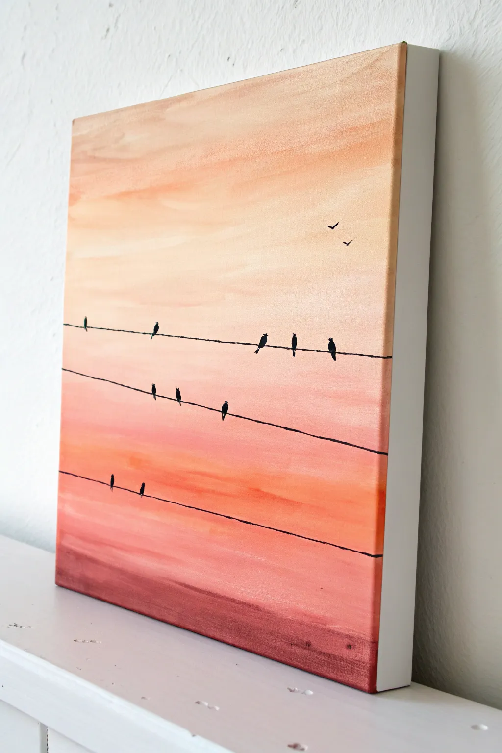 Minimal birds on a wire acrylic silhouette with a warm sunset wash and plenty of calm space.