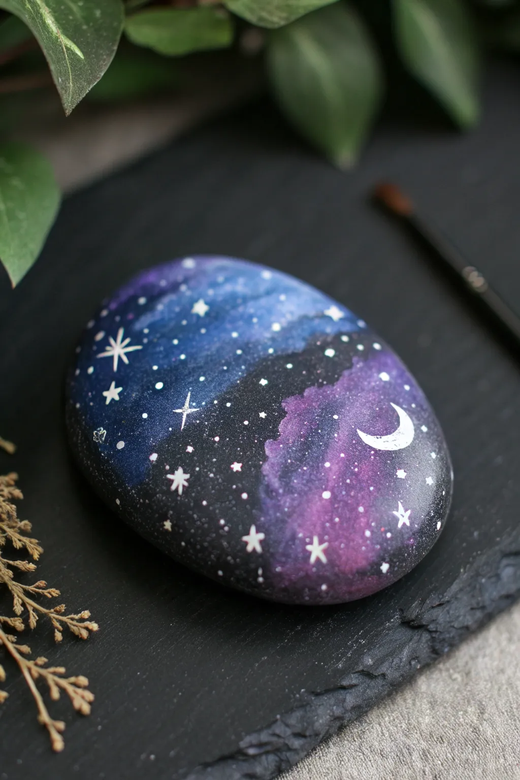 Galaxy night-sky stone art with moody lighting, star speckles, and a soft crescent moon