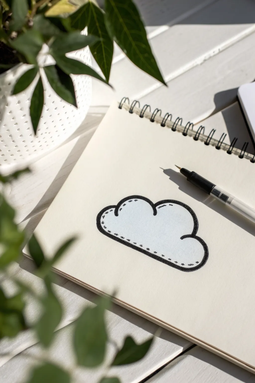 Chunky sticker-style cloud drawing with bold ink outline on bright white paper
