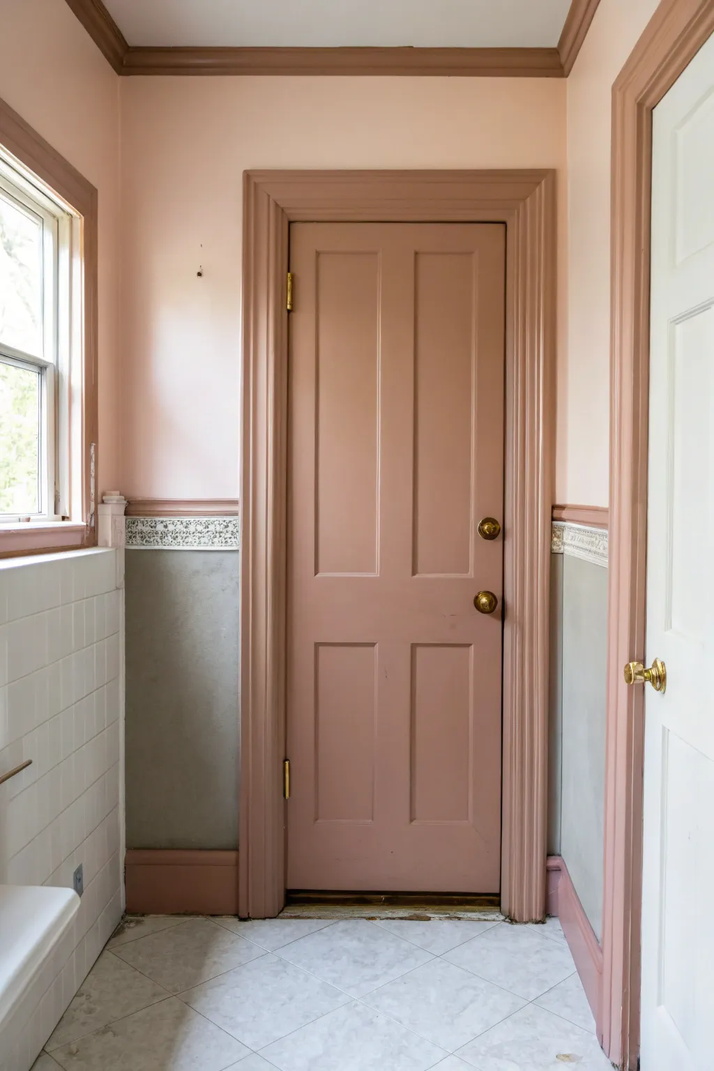 Color-drenched bathroom door in muted clay makes the entry feel calm, modern, and bold.