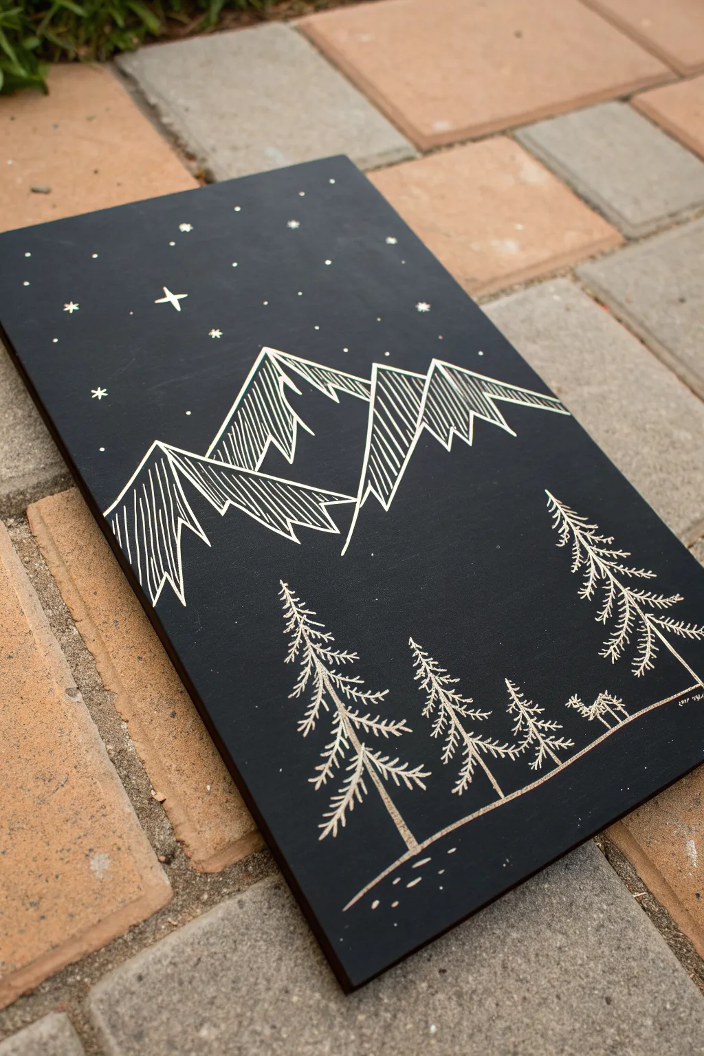 Beginner scratchboard: layered mountain ridge, tiny pine silhouettes, and soft star speckles
