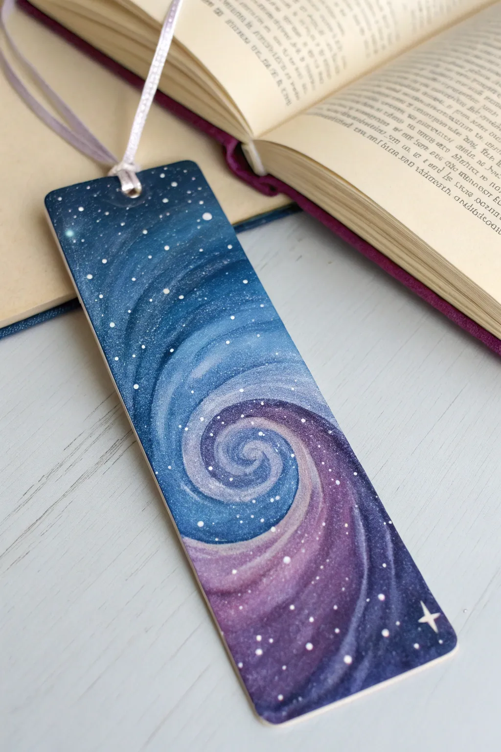 Paint a dreamy galaxy swirl bookmark with layered dots and a glowing center in acrylic