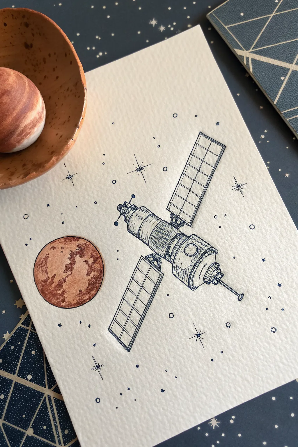 Minimal satellite sketch with geometric panels, starry dots, and a tiny planet in soft tones