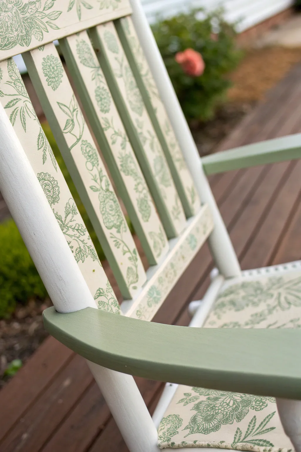 Soft stenciled florals on a painted rocking chair arm, Scandinavian calm with a boho touch.
